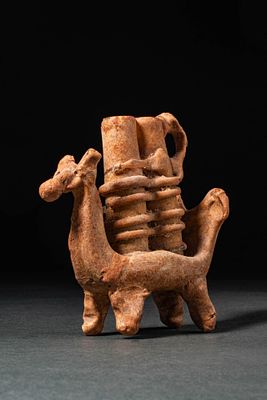 AN ABBASID ANIMAL-SHAPED GLASS UNGUENTARIUM. Ca. 7th-8th century AD. A glass flask in the shape 