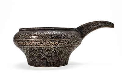 A PERSIAN SILVER ON COPPER SPOUTED POURING BOWL. Iran, Ca. 19th century AD. A finely engraved 