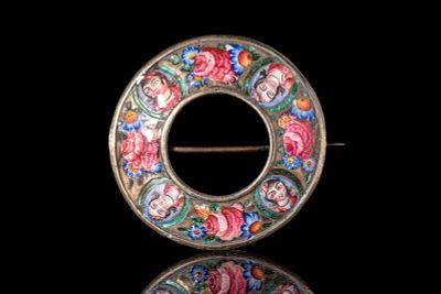 A QAJAR ENAMELLED PIN BROOCH. Qajar Iran, Ca. Late 19th century AD. A circular silver pin brooch 