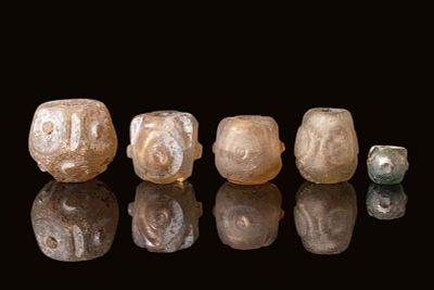 A GROUP OF EARLY ISLAMIC MOULD-BLOWN GLASS BEADS. Ca. 12th - 13th century AD. A set of early 