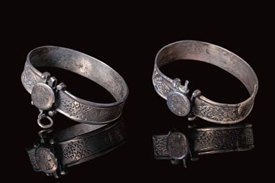 A PAIR OF SELJUK SILVER HINGED CUFF BRACELETS. Ca. 11th - 13th century AD. A pair of silver 