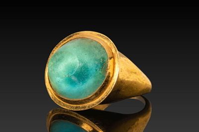 LATE ROMAN EARLY BYZANTINE TURQUOISE GLASS BEZEL IN HIGH KARAT GOLD RING. Ca. AD 100 - 300. A 