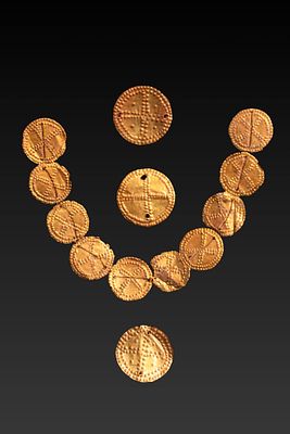 COLLECTION OF BRONZE AGE HIGH KARAT GOLD DISCS WITH CROSS. Ca. 2000 - 1500 BC. A group of 