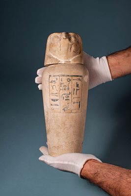 RARE EGYPTIAN LIMESTONE CANOPIC JAR WITH INSCRIPTION AND FALCON-HEADED LID. Third Intermediate 