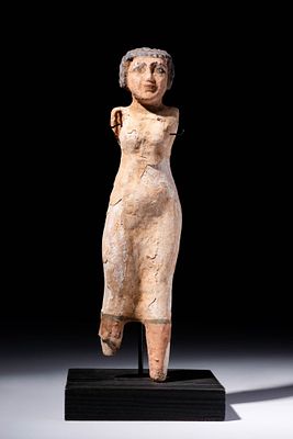 EGYPTIAN WOODEN FIGURINE OF WOMAN. Middle Kingdom, Ca. 2055 - 1790 BC. A wooden figure of a 