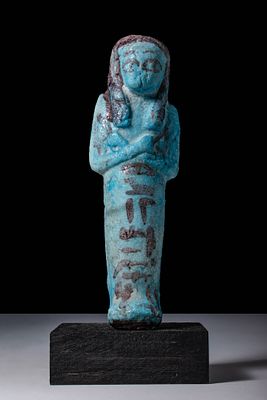 EGYPTIAN BICHROME FAIENCE USHABTI. Third Intermediate Period, Ca. 1069 - 664 BC. A bright blue 