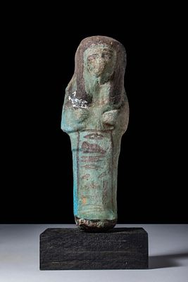EGYPTIAN BICHROME FAIENCE USHABTI. Third Intermediate Period, Ca. 1069 - 664 BC. A blue faience 