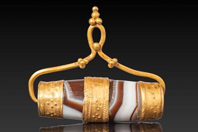BACTRIAN HIGH KARAT GOLD PENDANT WITH LARGE AGATE BEAD. Ca. 1300 - 900 BC. A barrel-shaped 