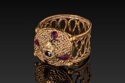 MEROVINGIAN OPENWORK HIGH KARAT GOLD RING WITH RED GARNET CABOCHONS. Ca. AD 800 - 1000. An 