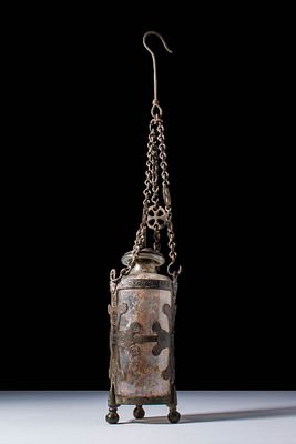 RARE BYZANTINE GLASS BOTTLE IN BRONZE OPENWORK SUSPENSION MOUNT. Ca. AD 500 - 700. A cylindrical 