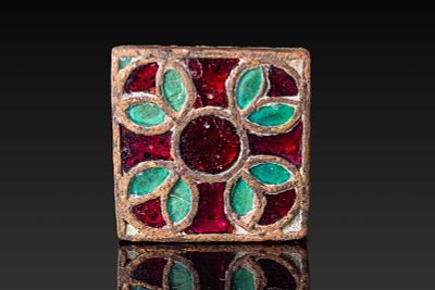 MEROVINGIAN GILT-BRONZE FITTING WITH CLOISONN&Eacute;. Ca. AD 400 - 600. A gilt-bronze mount of square 