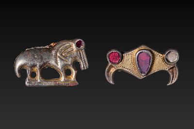 PAIR OF MEROVINGIAN SILVER-GILT BROOCHES WITH INSET GARNETS. Ca. AD 500 - 600. A pair of 
