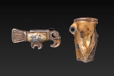 MEROVINGIAN GILT-BRONZE RAVEN BROOCH AND DRAGON-SHAPED SPOUT. Ca. AD 400 - 600. A pair 