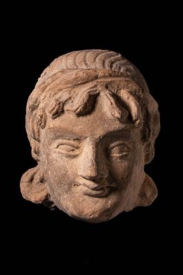 GANDHARAN TERRACOTTA HEAD OF YOUTH. Ca. AD 200 - 400. A carved stone head depicting a youthful 