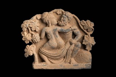 GANDHARAN STONE PANEL DEPICTING BACCHIC EROTIC SCENE. Kushan Period, Ca. AD 200 - 300. A finely 