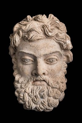 GANDHARAN STUCCO HEAD OF BEARDED MAN. Ca. AD 300 - 400. A stucco head finely modelled with 