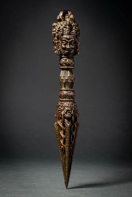 TIBETAN BRONZE PHURBA. Ca. 20th century AD. A ritual bronze phurba, cast with a three-sided 