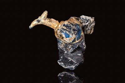 AN EARLY ISLAMIC MOULD-BLOW GLASS VESSEL IN THE FORM OF A CAMEL. Ca. 9th - 10th century AD. A 