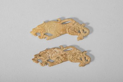 PAIR OF EASTERN ZHOU TYPE CARVED JADE TIGER PENDANTS. Ca. 19th-20th century AD. A pair of carved 