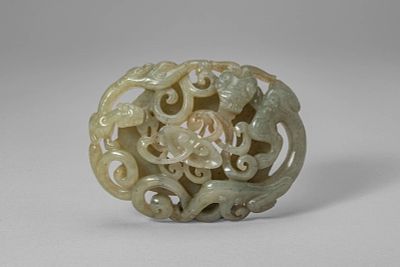 CHINESE JADE PLAQUE DEPICTING DOUBLE CHILONG. Ming Dynasty, Ca. 14th-17th century AD. An oval 