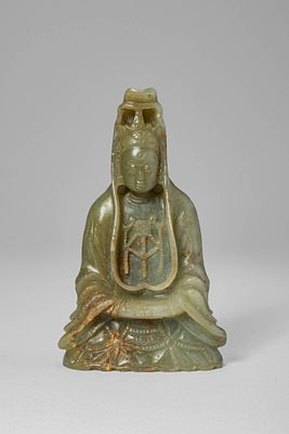 CHINESE JADE GUANYIN. Ca. 17th century AD. A figure of Guanyin carved from an even grey-green 