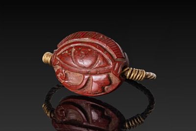 EGYPTIAN RED JASPER SCARABOID WITH WEDJAT EYE IN SILVER-GILT RING. Late Period, Ca. 664 - 332A 