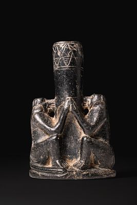 EGYPTIAN BLACK STONE KOHL TUBE WITH BABOONS. Late Period, Ca. 664 - 332 BCA black stone kohl 