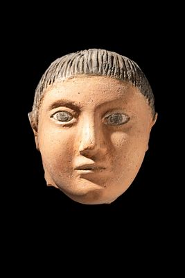 ROMANO-EGYPTIAN PLASTER MASK OF YOUTH. Ca. 30 BC - AD 200. A plaster mask of a youth with a 