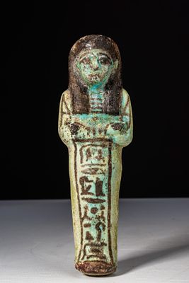 EGYPTIAN FAIENCE USHABTI WITH BLACK DETAILS. Third Intermediate Period, Ca. 1069 - 664 BC A 