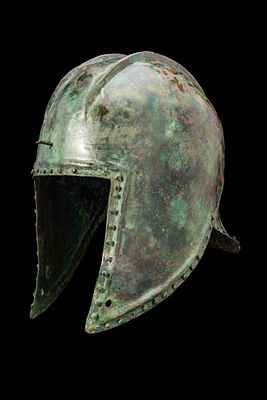 ILLYRIAN BRONZE HELMET. Ca. 500 BC A bronze helmet of Illyrian type with a tall domed skull with 