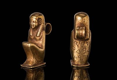PHOENICIAN HIGH KARAT GOLD ISIS AMULET. Ca. 600 - 400 BC. A gold pendant modelled as a seated 