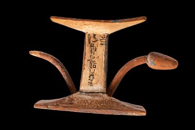 EGYPTIAN WOODEN HEADREST WITH LOTUS BUDS. Middle Kingdom, Ca. 2055 - 1790 BC. A wooden headrest 