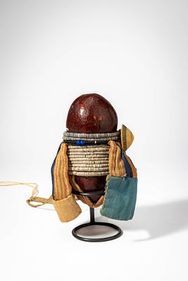 NAMIBIA HERERO DOLL. Ca. 20th century AD. >A wooden doll with a carved head and cylindrical body 