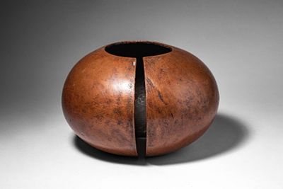 ZAIRE MBOLE COPPER ANKLET. Ca. 20th century AD. >A heavy anklet of rounded ovoid form with a 