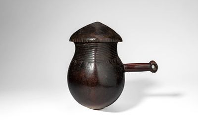 ZAIRE WOODEN SHI MILK POT AND LID. Ca. 20th century AD. >A wooden milk pot of globular form with 
