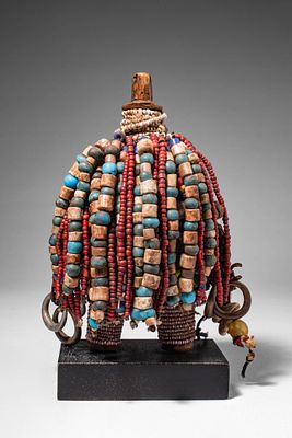 CAMEROON NAMJI DOLL. Ca. 20th century AD. >A small wooden figure with short legs and a 