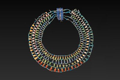 EGYPTIAN FAIENCE BROAD COLLAR WITH LEAVES, PETALS AND FRUIT. Amarna Period, Ca. 1353 - 1336 BC. 