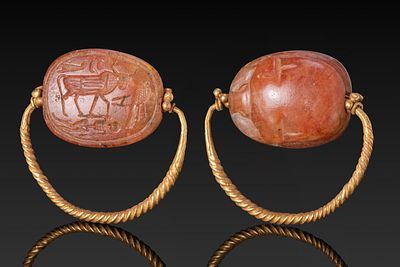 EGYPTIAN GOLD RING WITH CARNELIAN SCARAB WITH KING AS BULL MOTIF. New Kingdom, Ca. 1550 - 1069 