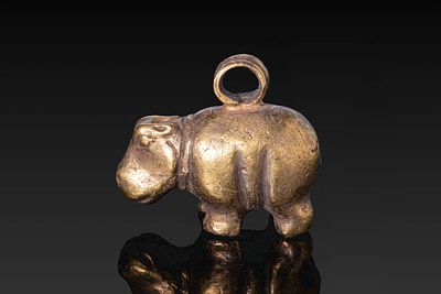 EGYPTIAN GOLD HIPPOPOTAMUS PENDANT. Middle Kingdom, Ca. 2055 - 1790 BC. A gold pendant in the 