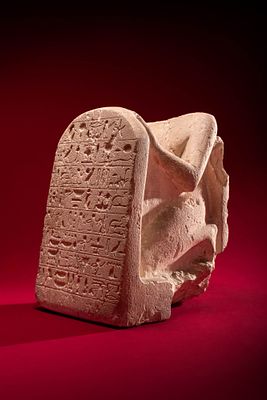 STUNNING EGYPTIAN LIMESTONE STELOPHOROUS STATUE WITH INSCRIBED STELA. New Kingdom, Ca. 1294 - 