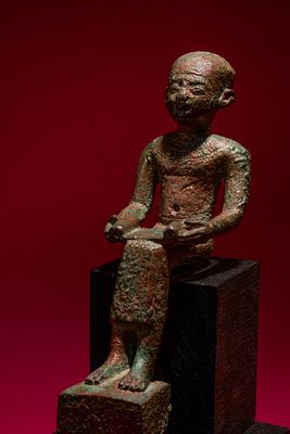 EGYPTIAN BRONZE FIGURINE OF DEIFIED ARCHITECT IMHOTEP. Late Period to Ptolemaic Period, Ca. 664 