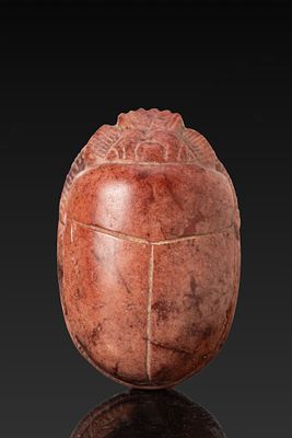 LARGE EGYPTIAN RED STONE SCARAB. New Kingdom, Ca. 1550 - 1069 BC. A red stone scarab with a 