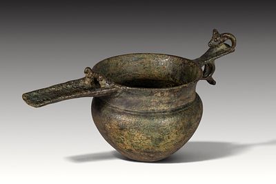 AMLASH BRONZE VESSEL WITH SPOUT AND ANIMAL-SHAPED HANDLE. Ca. 1000 BC. A bronze vessel with a 