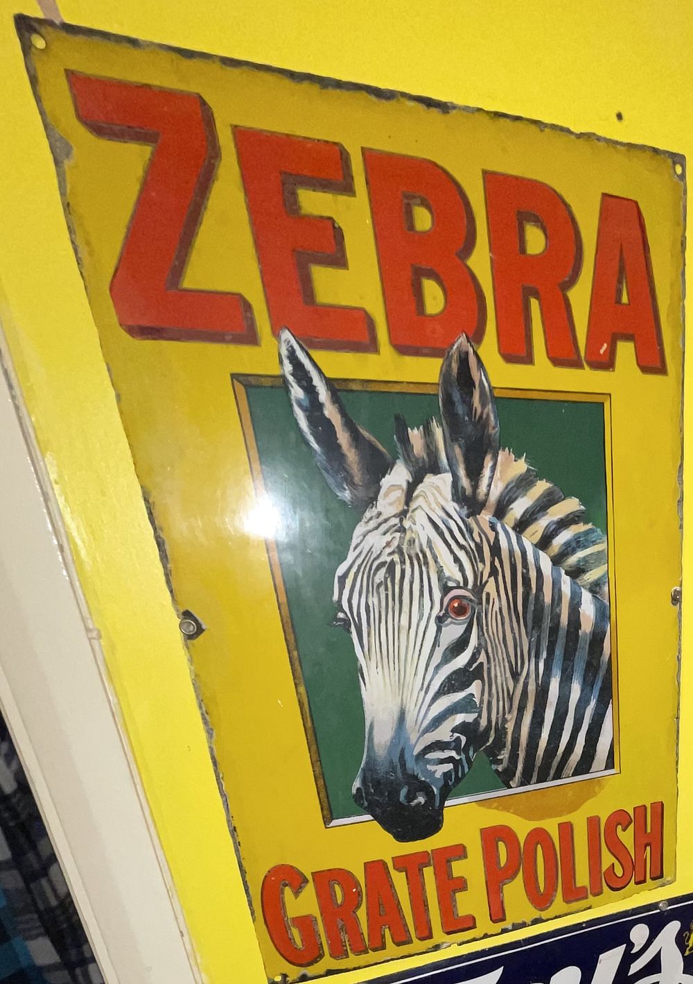 Lot 14: A Zebra Grate Polish Vitreous Enamel Advertising Sign