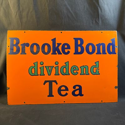 Brooke Bond Dividend Tea Enamel Advertising Sign. Orange background with navy blue serif font 