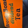 Brooke Bond Dividend Tea Enamel Advertising Sign. Orange background with navy blue serif font Image - 3
