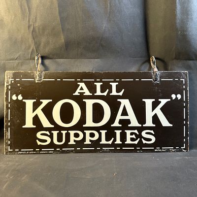 Kodak Enamel Advertising Sign. Double-sided steel with black background and bold white serif 