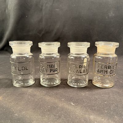 Apothecary Jars Set of Four. Set of four early 20th-century clear glass apothecary jars. Ground 