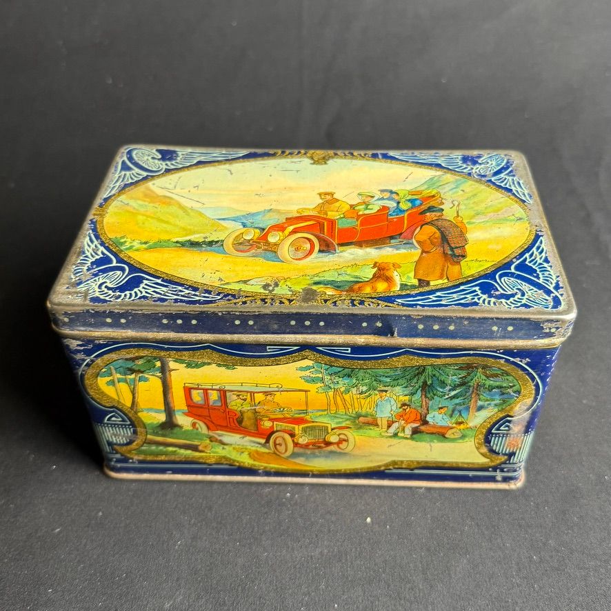 Lot 153: A Tin depicting various Motoring scenes A colourful...