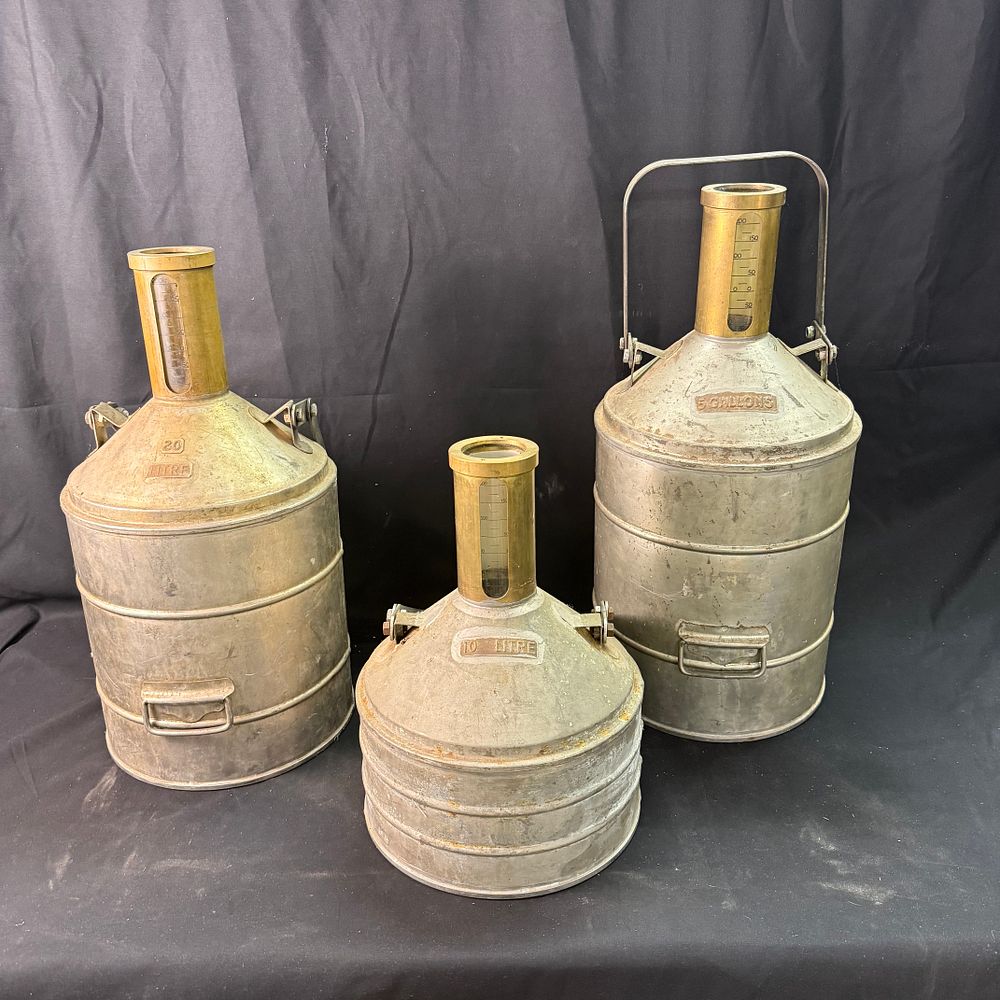 Lot 168: Trio of Metal Liquid Measuring Vessels
